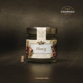 Honigglas mit Bezeichnung und Blumenillustration auf dunklem Hintergrund.