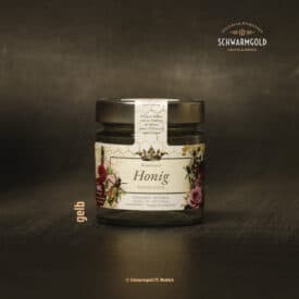 Honigglas auf dunklem Hintergrund.